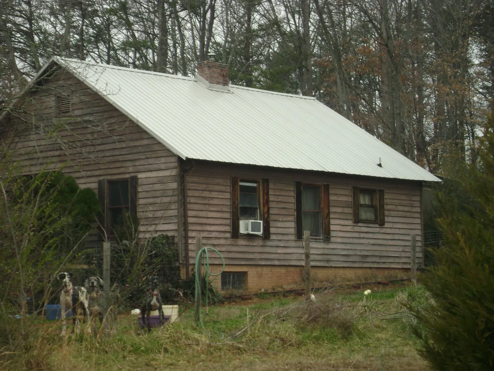 White metal roof on an old wood sided farmhouse, from a Metal Roof Installation job in La Junta